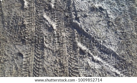 car truck tyre print pattern on dirty black sand