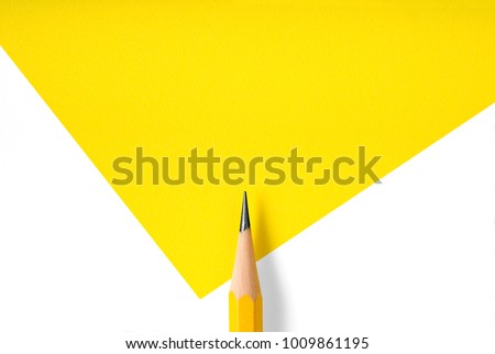 Minimalist template with copy space by top view close up macro photo of wooden yellow pencil isolated on white texture paper and combine with yellow graphic.Flash light made smooth shadow from pencil. Royalty-Free Stock Photo #1009861195