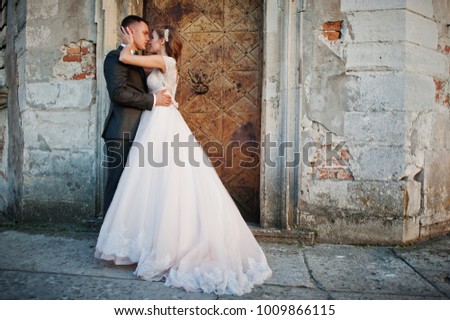 Beautiful wedding couple posing next to the main castle doors.