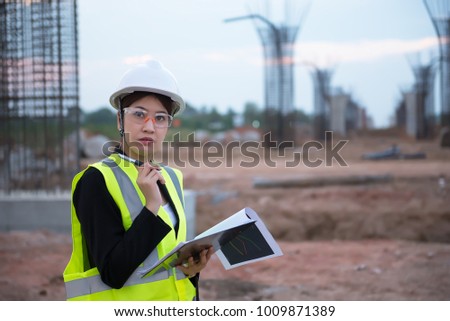 Engineer woman working at site of bridge under construction