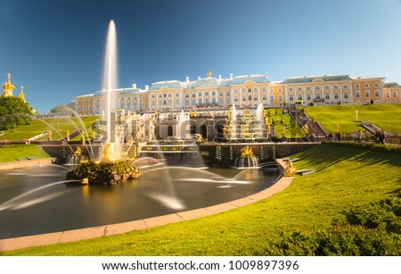 PETERHOF, RUSSIA,  Grand cascade in Pertergof, St-Petersburg. the largest fountain ensembles. Wide angle lens and long exposition. Summer blue sky. Royalty-Free Stock Photo #1009897396