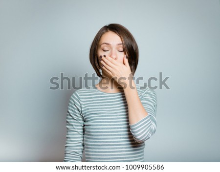 business woman covers her mouth with her hands, isolated on background, studio photo
