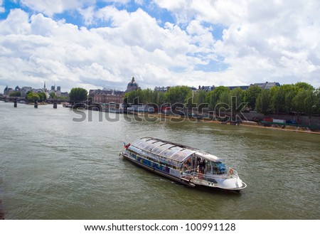 The image of a survey on the tour boat on the river Seine along the sights of Paris. France.