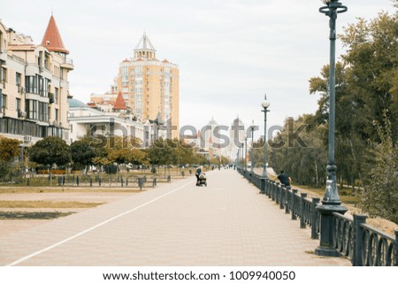 Cityscape. Urban road in a typical street of modern buildings in big city. Bird and green trees in residential district. pedestrian zone. Kyiv. Ukraine