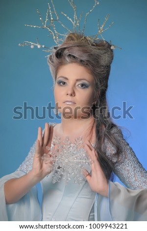 winter queen holds a snowflake in her hands