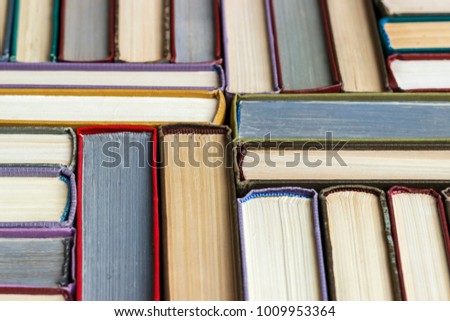 Stacks of colored books on a wooden table. concept of reading habits