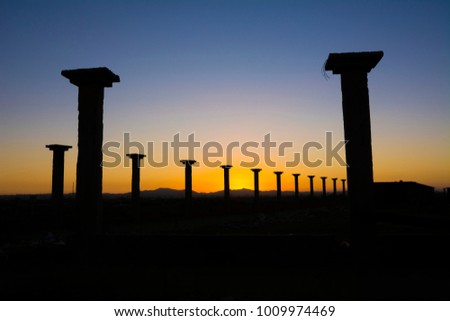 Column silhouette in sunrise background