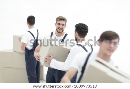 Portrait of movers holding box smiling isolated on white background