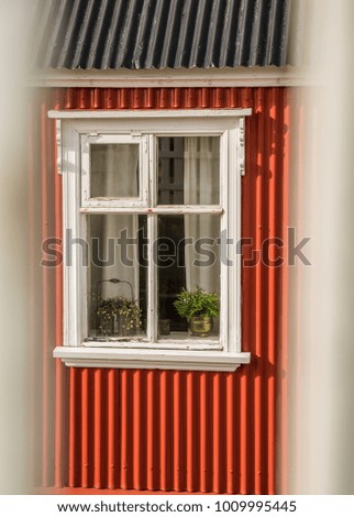 Window of a red painted house