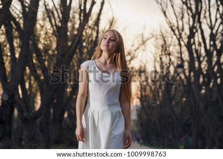 Girl in a white dress in the fairy forest. Mystery night.