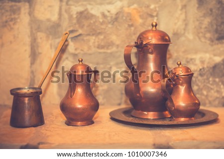 Antique brass retro teapot and coffee set. Vintage filter effect. Copy space.