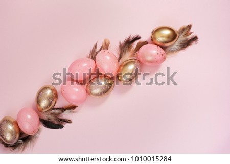 Pink and Gold Easter Eggs. Pastel Easter Concept with Eggs and Feathers. Punchy Pastels.