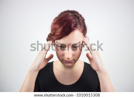 A young girl with facial expression, and hands shows that the pain is headache, headache, pain, white background, facial expressions
