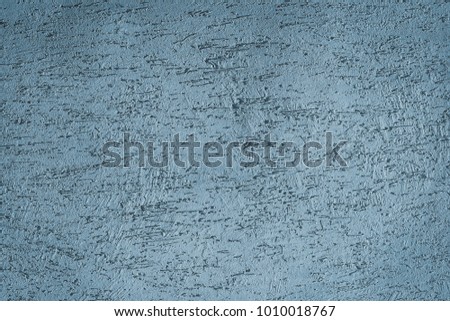 texture of the concrete wall covered with irregularities and scratches. toned. background.