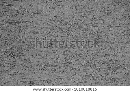 texture of the concrete wall covered with irregularities and scratches. toned. background.