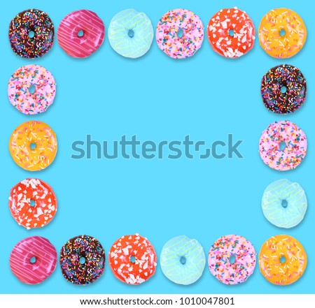 doughnuts with colorful icing and sprinkles on an isolated white background studio shot overhead with shadows
