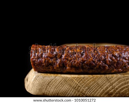 Aromatic regional pork sausage lying on a wooden board