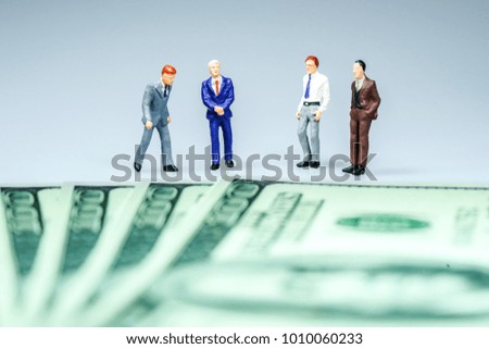 Miniature people : Businessman with US dollar bills. Business concept.