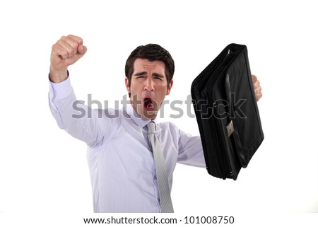 happy businessman raising his briefcase and fist