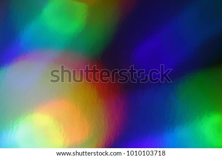 Natural effect holographic foil. Colorful of bokeh on defocused background. Holographic background with multiple colors. Out of focus texture.