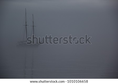 Ship on a foggy morning, ghost ship in fog Royalty-Free Stock Photo #1010106658