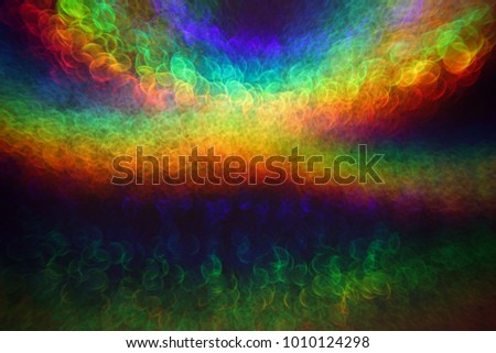 Holographic background with multiple colors. Out of focus texture. Holographic wrinkled abstract foil texture with multiple colors. Colorful of bokeh on defocused background. Natural effect.