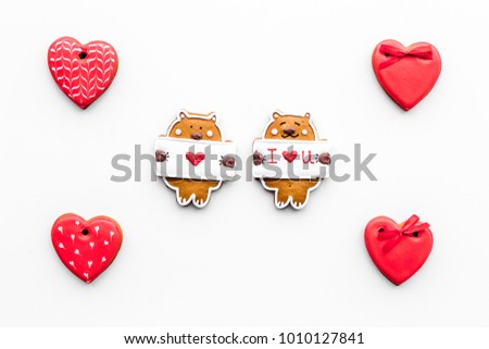 Sweet gift on Valentine's Day. Heart shaped cookies and bear with lettering I love you on white background top view