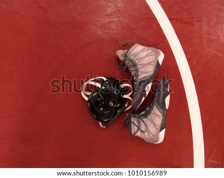 Wrestling gear on mat Royalty-Free Stock Photo #1010156989