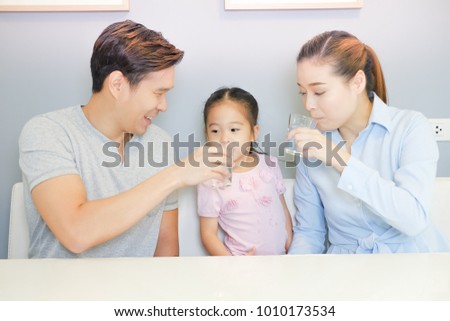 Asian family drinking water with together Royalty-Free Stock Photo #1010173534