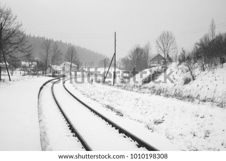 Empty rails in the winter rural landscape