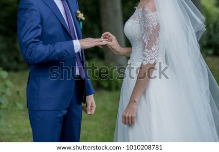 the bride and groom put on rings