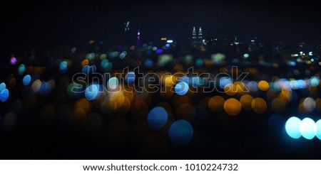 Blurred dramatic night view of city with abstract of LED, neon lights and beautiful bokeh.                     