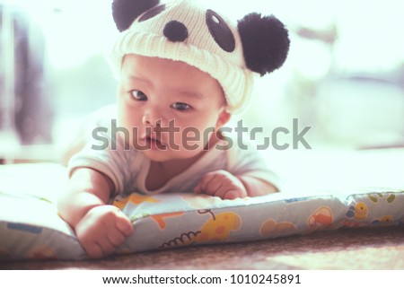 a close-up isolated asian baby in panda hat photo