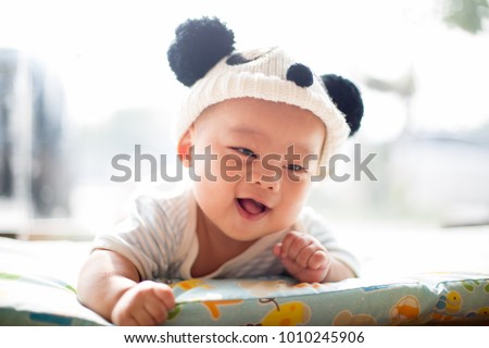 a close-up isolated asian baby in panda hat photo