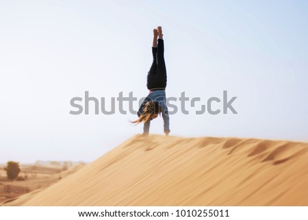 Young girl playing in desert in Dubai UAE
