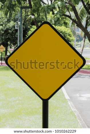 yellow sign at the park , background is garden, with copy space