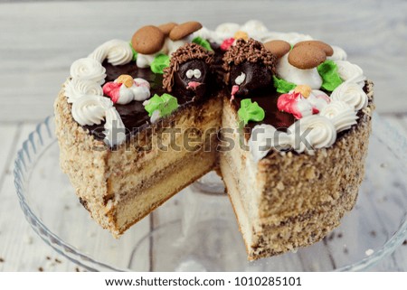 dark chocolate vegan cake with cream and caramel on wooden background