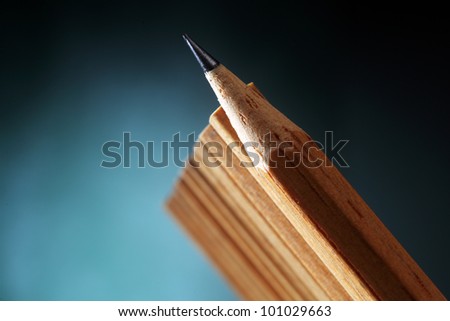 One sharpened pencils in row with pencil ends,