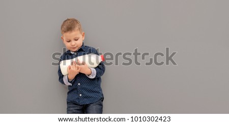 Smiling child boy drinking milk