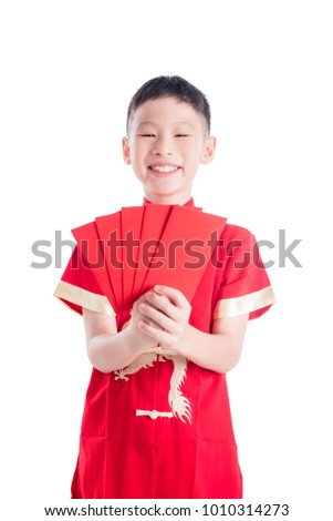 Young asian boy smiling while holding red packet money isolated background