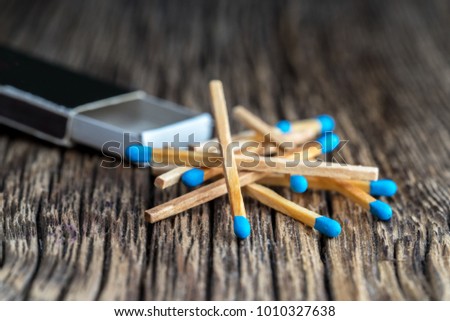 Safety matches and box on wooden textured table, close-up