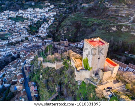 Aerial view of the "Cazorla" village castle, with its main tower rising above the village. Different angles and views.