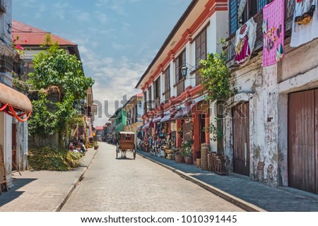 City Center Street Scene in Historic Colonial Town With Horse and Carriage (Vigan, Luzon, Philippines). Royalty-Free Stock Photo #1010391445