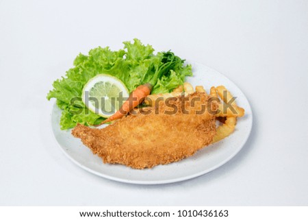 Fish and chips served with  salad and lemon