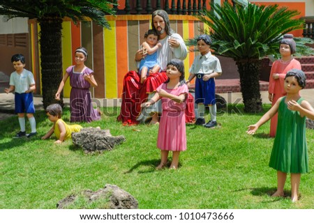 Statue of Jesus Christ sitting with children in garden, Thailand
