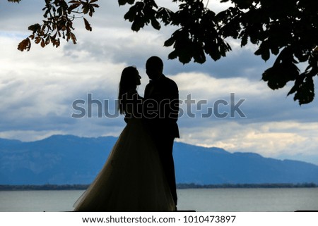 The silhouetted figures of a bride and groom make for a romantic photography
