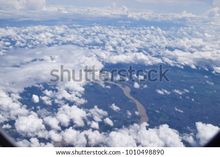 Beautiful clouds sky and river view landscape background by window plane
