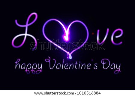 a glowing neon inscription  of a happy Valentine's Day on a dark background