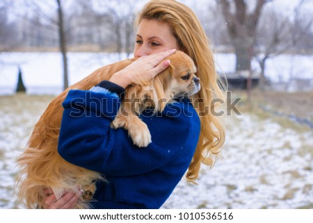 Nice young woman on a walk with her dog resting at park. Best friendship girl and senior dog. Psychology of dog owner