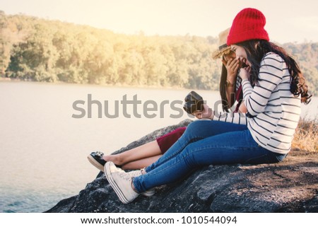 Asian women shooting picture in nature , Relax time on holiday concept travel,selective and soft focus,tone of hipster style